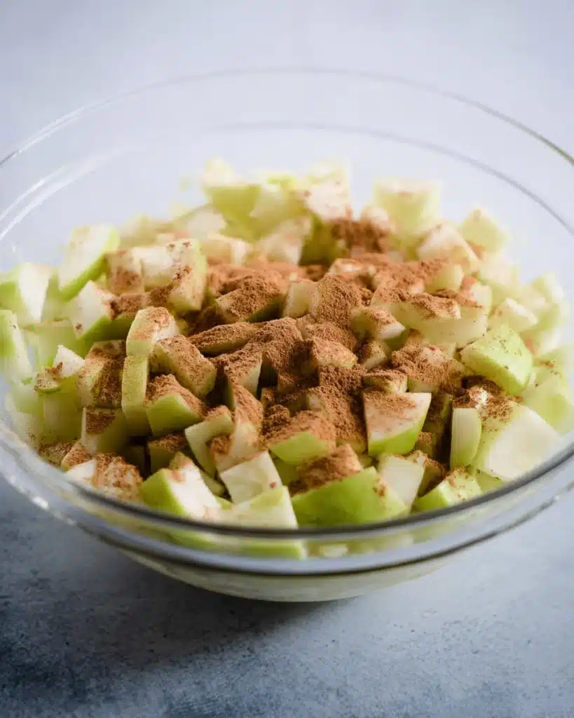 Apple Cheesecake Bars (Perfect for Thanksgiving) 3 Chopped Granny Smith apples with cinnamon for Apple Cheesecake Bars