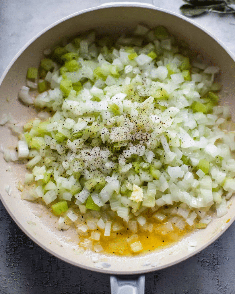 Onions and celery sautéing in butter for buttery herb stuffing