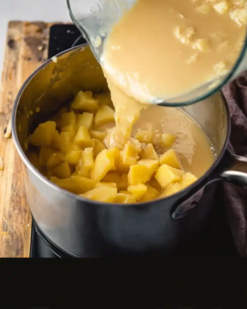 Blended potatoes poured back into soup pot with broth and chunks