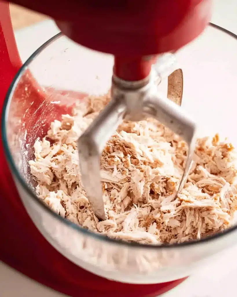 Shredded chicken in glass bowl for chicken sandwiches