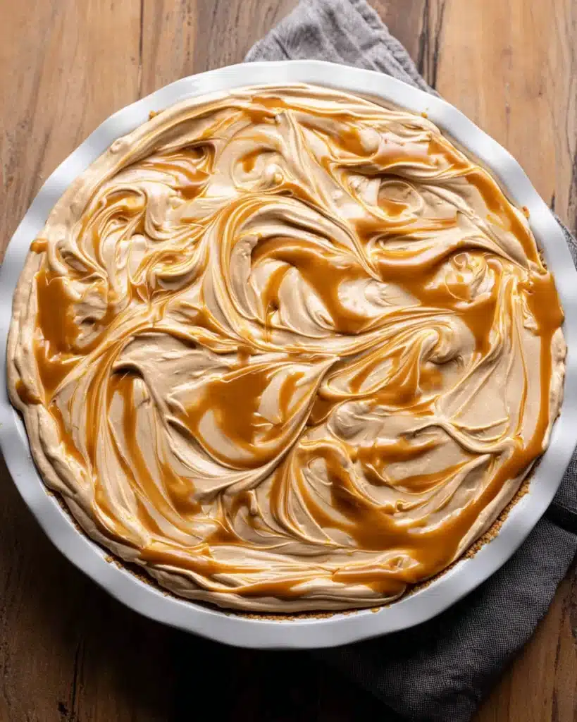 Chocolate Peanut Butter Pie (Thanksgiving Favorite) 8 Peanut butter swirl topping on chocolate peanut butter pie before chilling