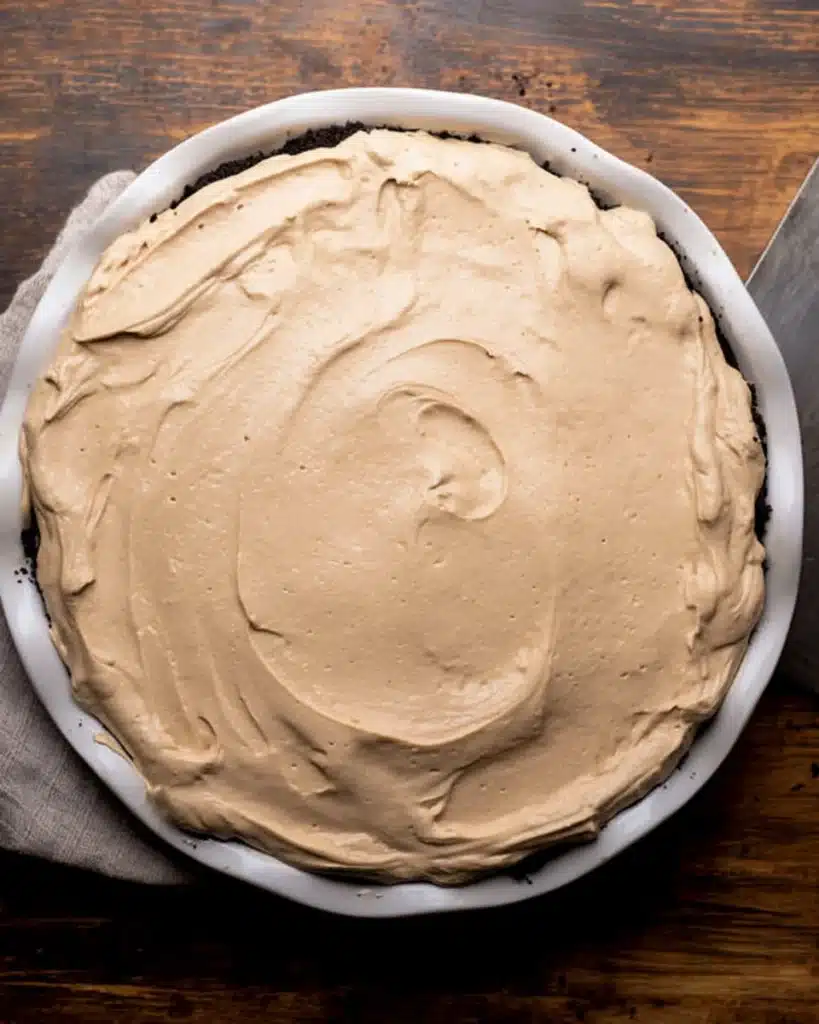 Chocolate Peanut Butter Pie (Thanksgiving Favorite) 7 Peanut butter layer spread on chocolate pie in Oreo crust