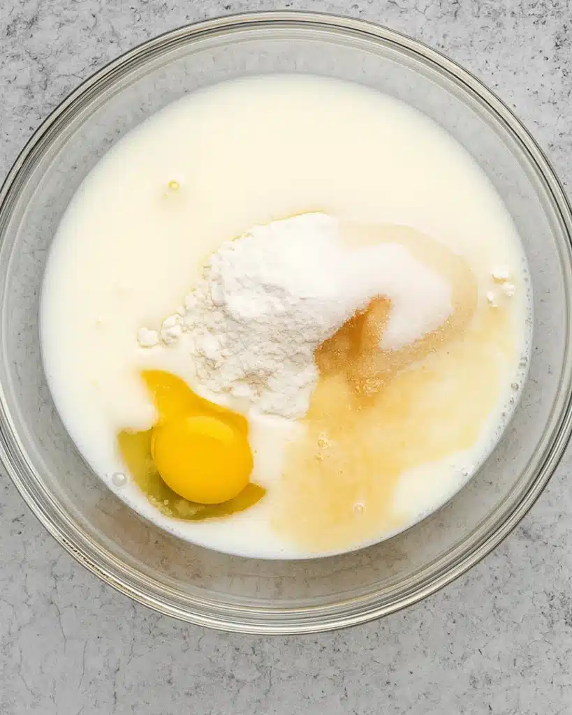 Cinnamon Roll Cake with Cream Cheese Frosting | Perfect Thanksgiving Dessert 2 Cinnamon Roll Cake with Cream Cheese Frosting batter ingredients in a glass bowl