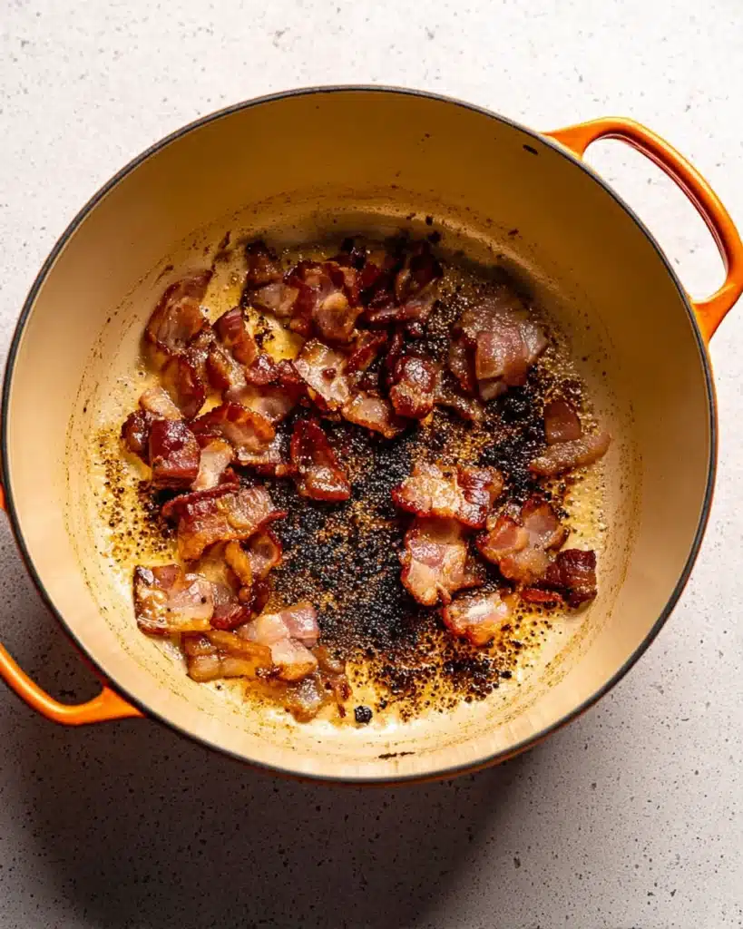 Classic Beef Bourguignon (Christmas Recipe) 2 Crispy bacon cooking in Dutch oven for classic beef bourguignon