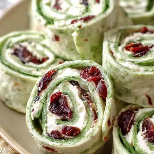 Cranberry and Feta Pinwheels 6 Cranberry and feta pinwheels with spinach tortillas on a plate