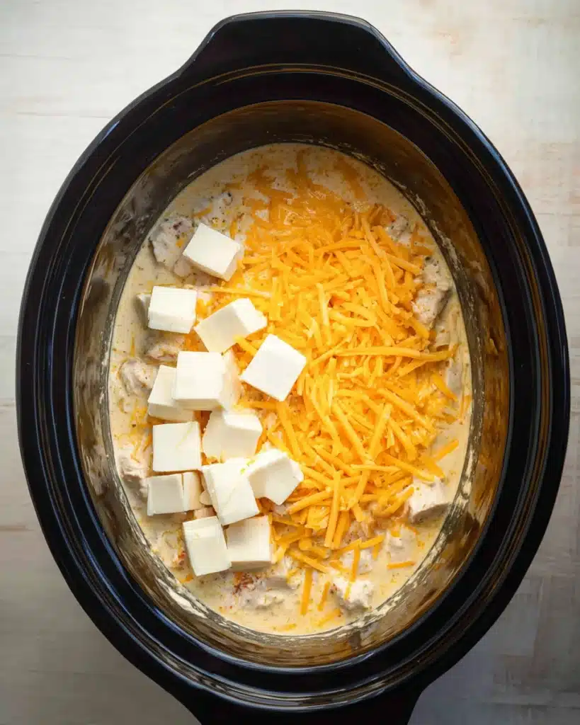 Shredded cheddar and cream cheese added to CrockPot Cheesy Chicken Spaghetti