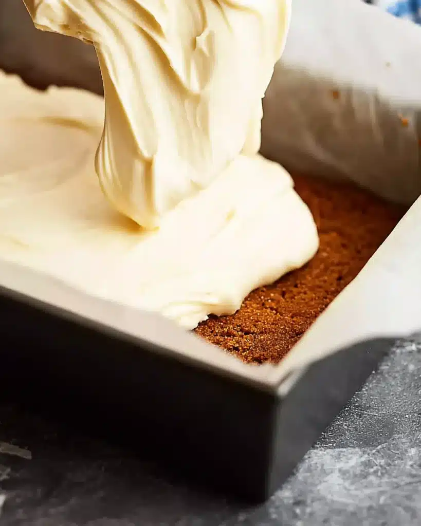 Easy Christmas Cheesecake Slab – No Bake Recipe 3 Cheesecake filling spread over spiced biscuit crust in pan