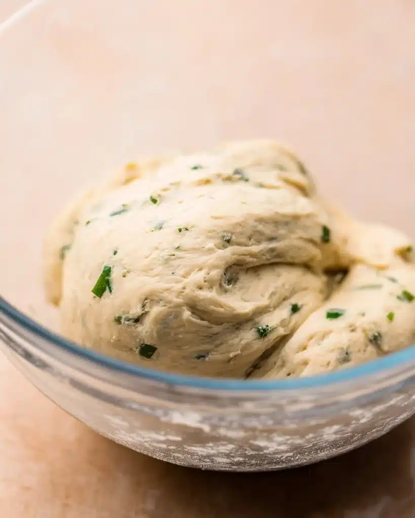 Easy Garlic Bread Rolls (Perfect for Thanksgiving) 3 Herb dough in glass bowl for Easy Garlic Bread Rolls