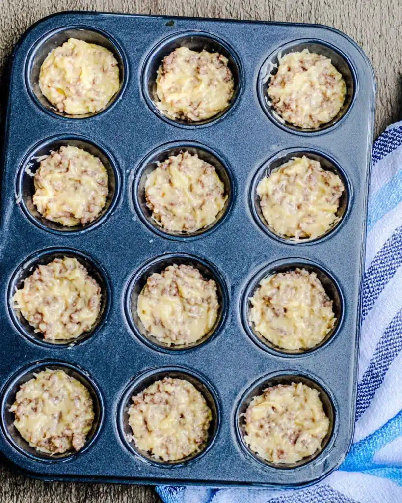 Easy Sausage Pancake Bites 3 Muffin tin filled with raw Easy Sausage Pancake Bites batter before baking