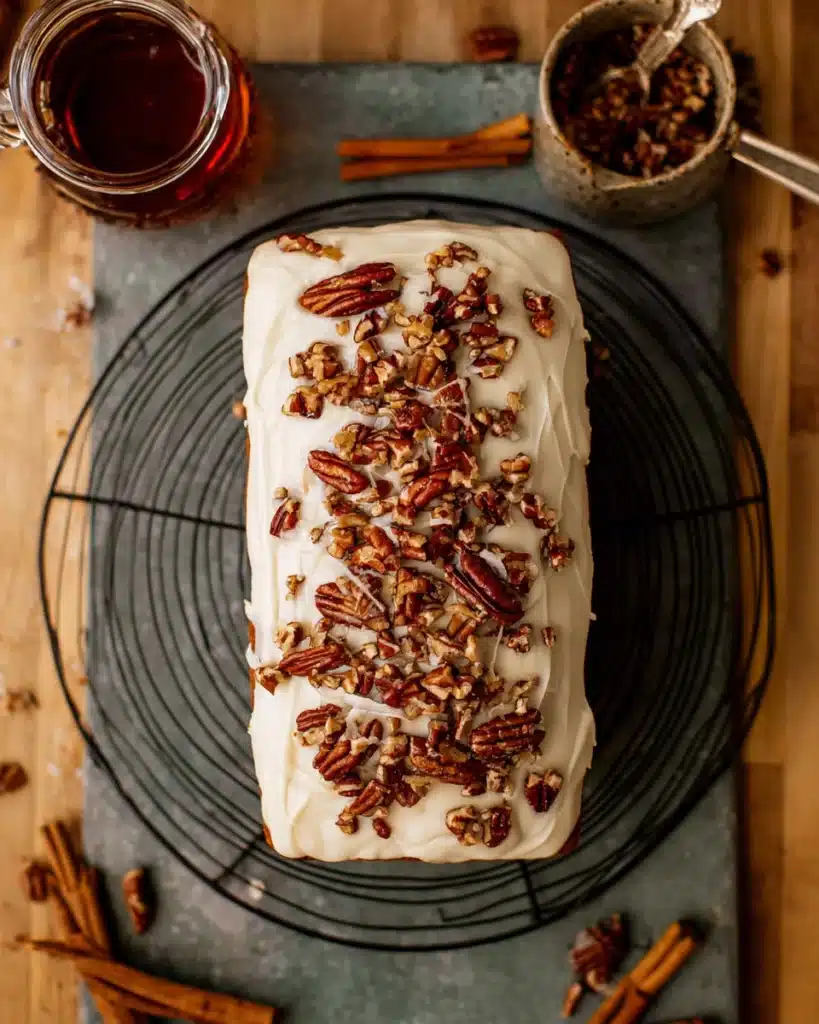 Frosted Pumpkin Bread 12 Frosted pumpkin bread topped with candied pecans on cooling rack