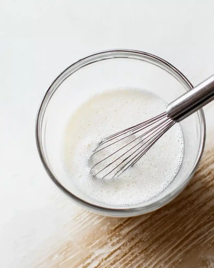 Whisking milk and yogurt for healthy pumpkin pancakes