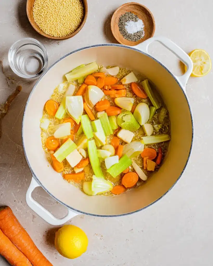 Italian Penicillin Soup Recipe 2 Sautéed carrots, celery, onion, and garlic in a pot for Italian penicillin soup