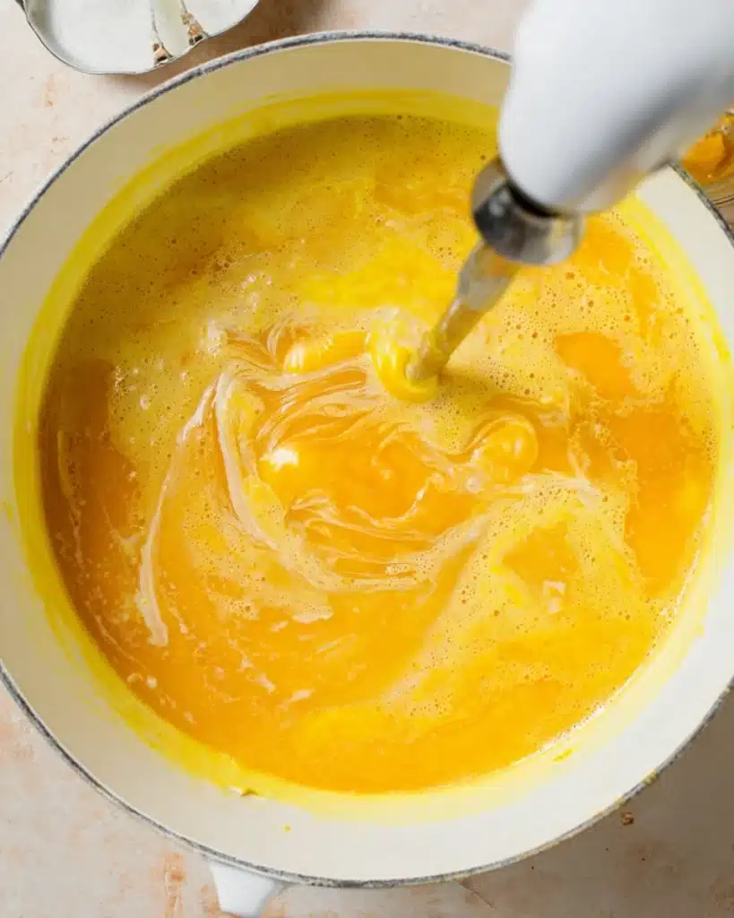 Italian Penicillin Soup Recipe 5 Blending Italian penicillin soup with an immersion blender in a white pot