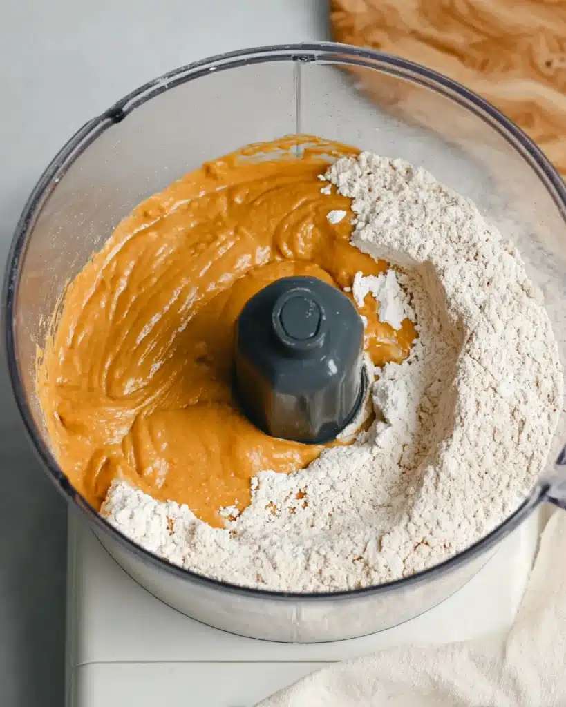 Pumpkin Scones Recipe – Perfect Fall Treat 4 Pumpkin batter poured over flour mixture in food processor