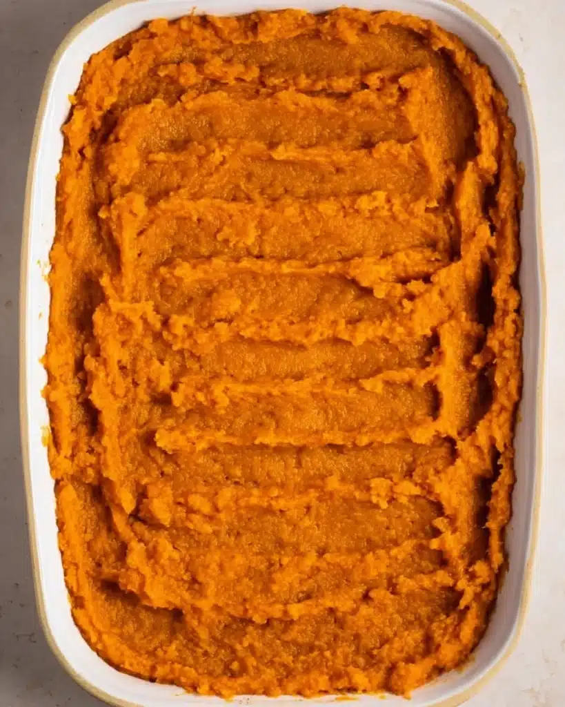 Sweet Potato Casserole with Marshmallows 5 Sweet potato casserole base spread in a white baking dish