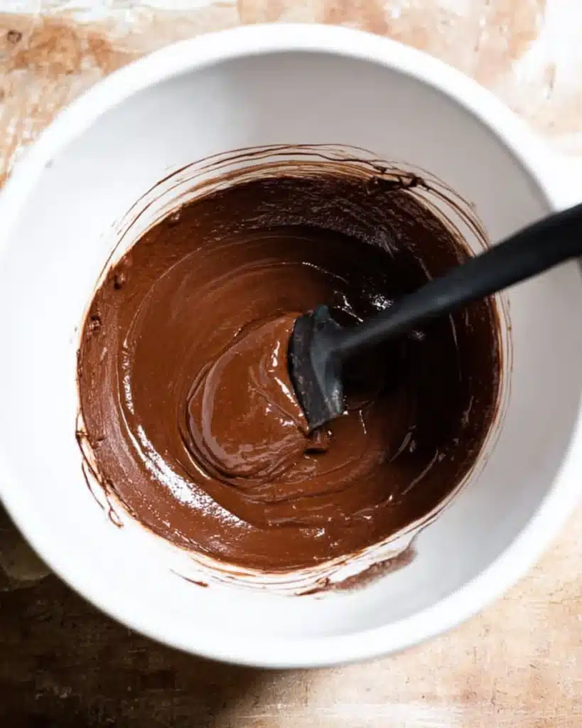 The BEST Fudgy Chewy Brookies (Christmas Recipe) 4 Glossy chocolate brookie batter in a white bowl with spatula