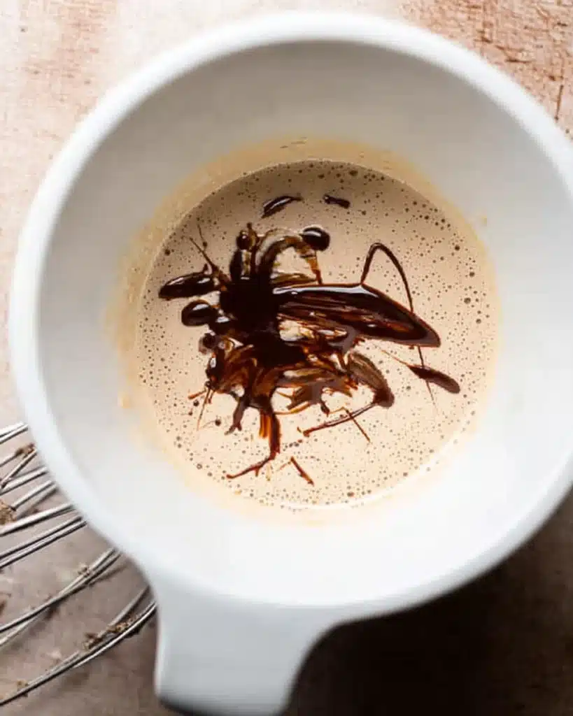 The BEST Fudgy Chewy Brookies (Christmas Recipe) 3 Whisked eggs and sugar with melted chocolate in mixing bowl for brookies
