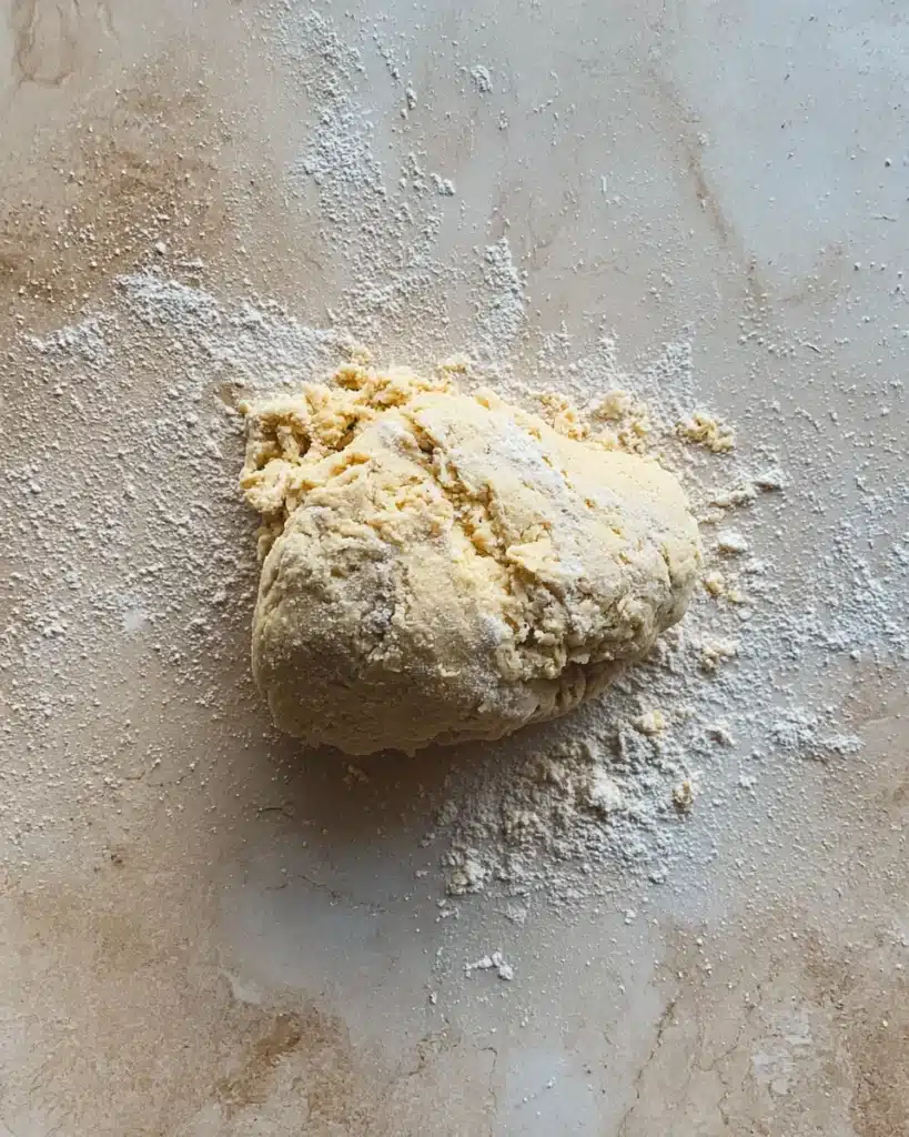 The Best Cinnamon Rolls EVER (Halloween Edition) 3 Rough cinnamon roll dough ball on floured countertop