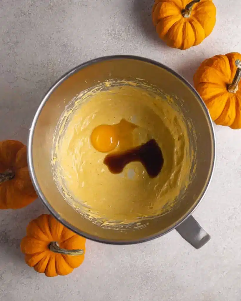 The Best Pumpkin Cheesecake Bars Ever 5 Egg and vanilla added to pumpkin cheesecake batter in bowl