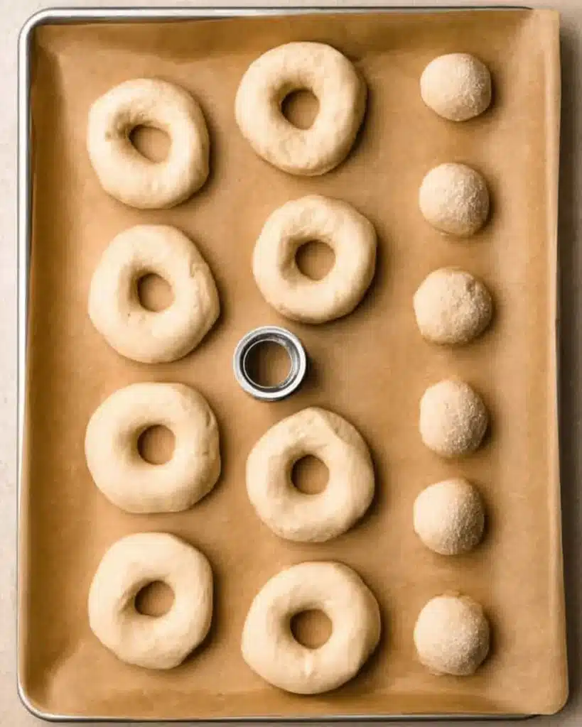 Air Fryer Biscuit Donuts – Quick, Easy, and Irresistibly Fluffy 2 Raw biscuit dough shaped into donuts and holes on parchment paper