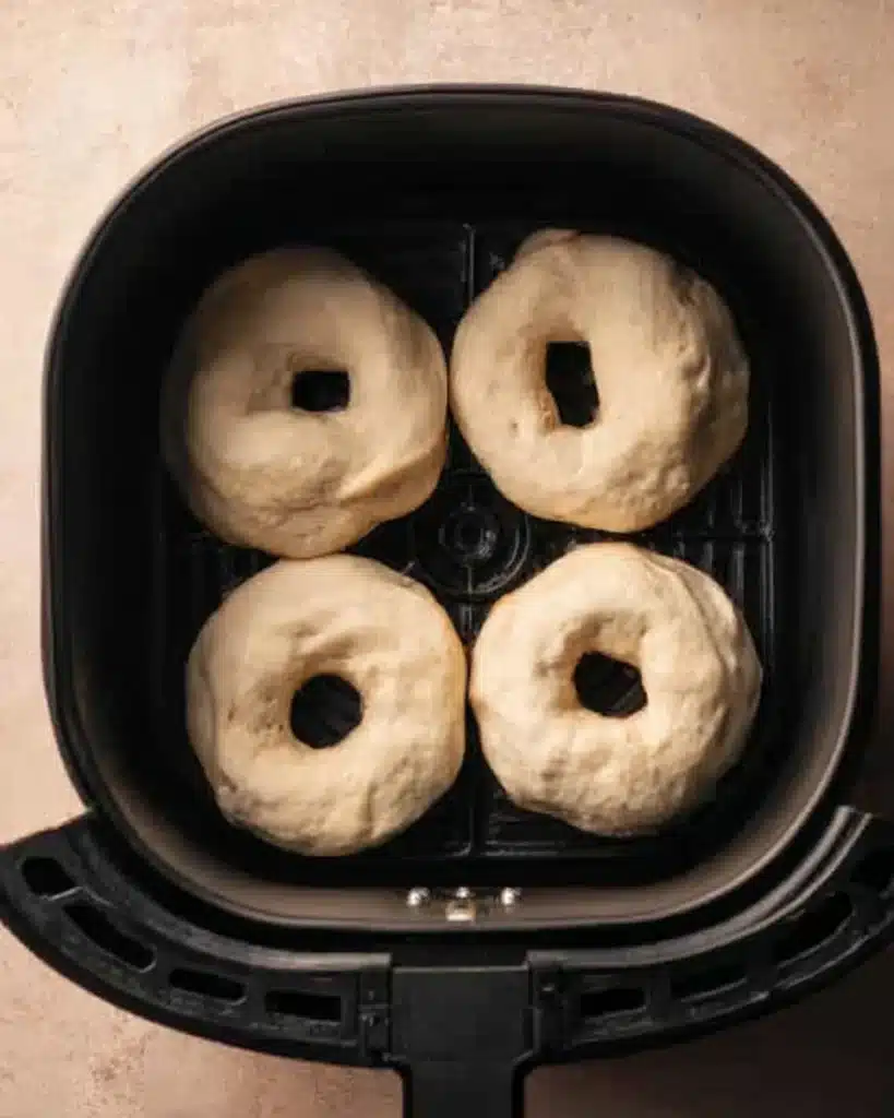 Air Fryer Biscuit Donuts – Quick, Easy, and Irresistibly Fluffy 3 Uncooked biscuit donuts in an air fryer basket before cooking