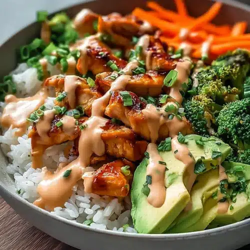 Bang Bang Chicken Bowl with rice, avocado, and creamy spicy sauce