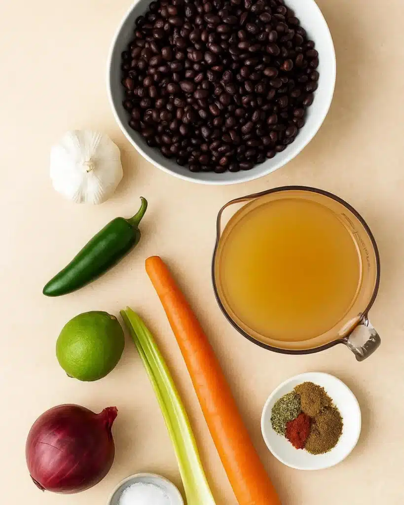 Black Bean Soup 2 Flat lay of black bean soup ingredients on a beige stone background