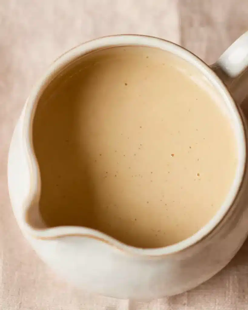 Bread Pudding with Vanilla Sauce 8 Creamy vanilla sauce in a white ceramic pitcher