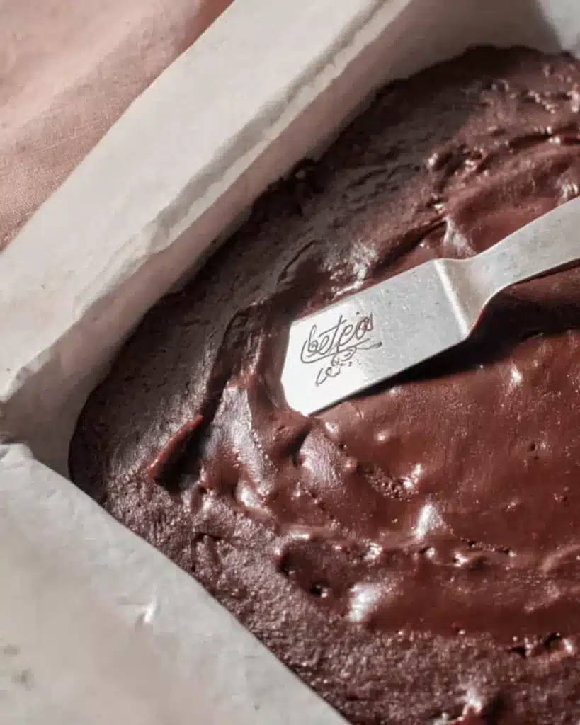 Brownie Recipe (Best Fudgy & Chewy Brownies Ever) 6 Spreading brownie batter in baking pan with spatula