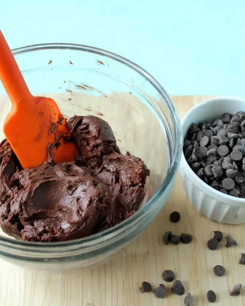 Cake Mix Cookies – The Easiest 3-Ingredient Dessert Ever! 2 Chocolate cookie dough with spatula and chocolate chips in mixing bowl