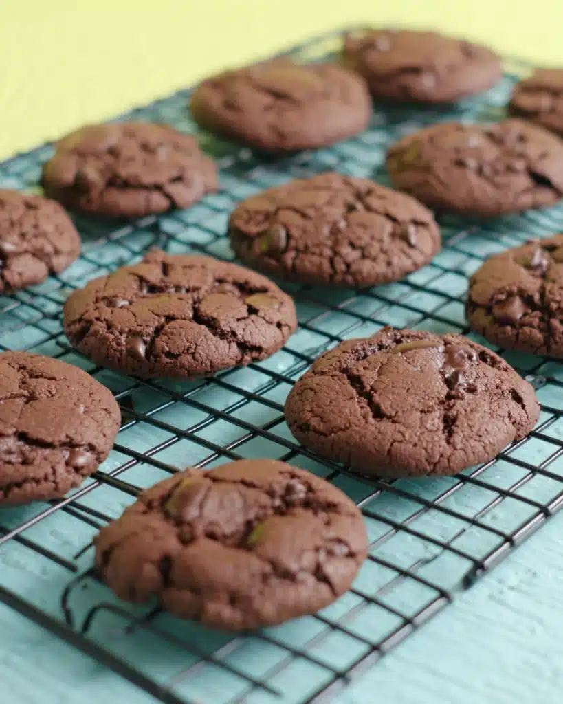 Cake Mix Cookies – The Easiest 3-Ingredient Dessert Ever! 4 Freshly baked chocolate cake mix cookies cooling on a wire rack