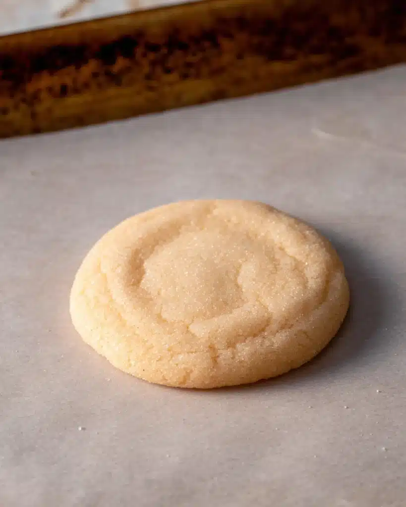 Chewy Sugar Cookies 7 Freshly baked chewy sugar cookie on parchment paper