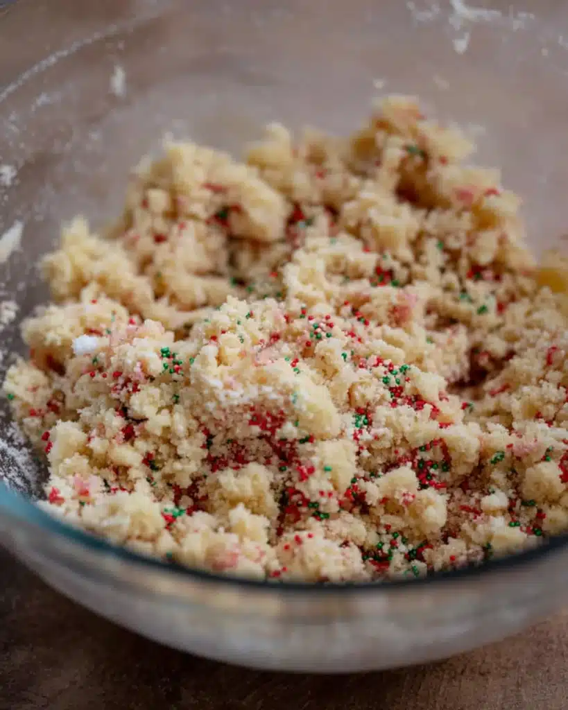 Christmas Tree Cake Truffles Recipe (No-Bake Holiday Treat) 2 Crumbled cake mixture for Christmas Tree Cake Truffles in glass bowl