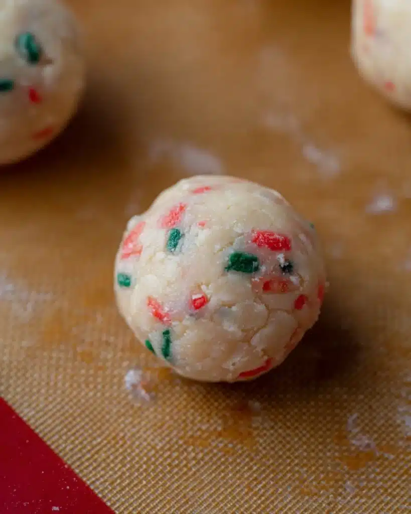 Christmas Tree Cake Truffles Recipe (No-Bake Holiday Treat) 3 Uncoated Christmas Tree Cake Truffle ball with red and green sprinkles