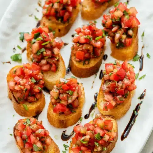 Classic Bruschetta Recipe (Easy Italian Appetizer) 9 Classic bruschetta with tomatoes, basil, and balsamic glaze on crispy baguette slices