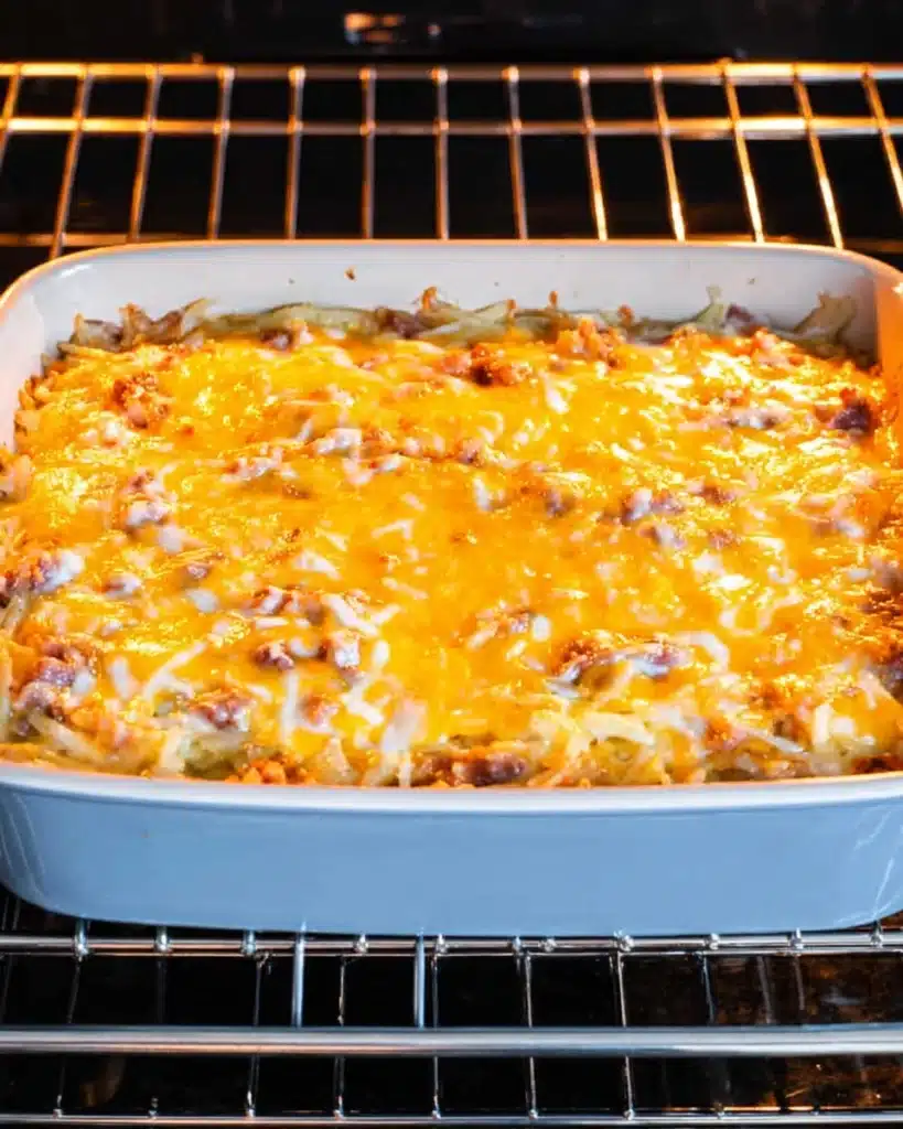 Crack Breakfast Casserole 5 Crack Breakfast Casserole baking in oven with melted cheese topping