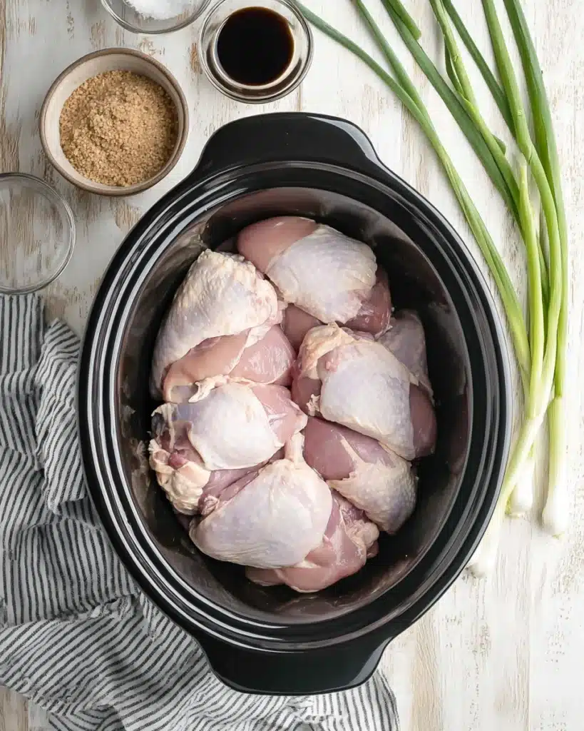 Raw chicken thighs in slow cooker for Crock Pot bourbon chicken recipe