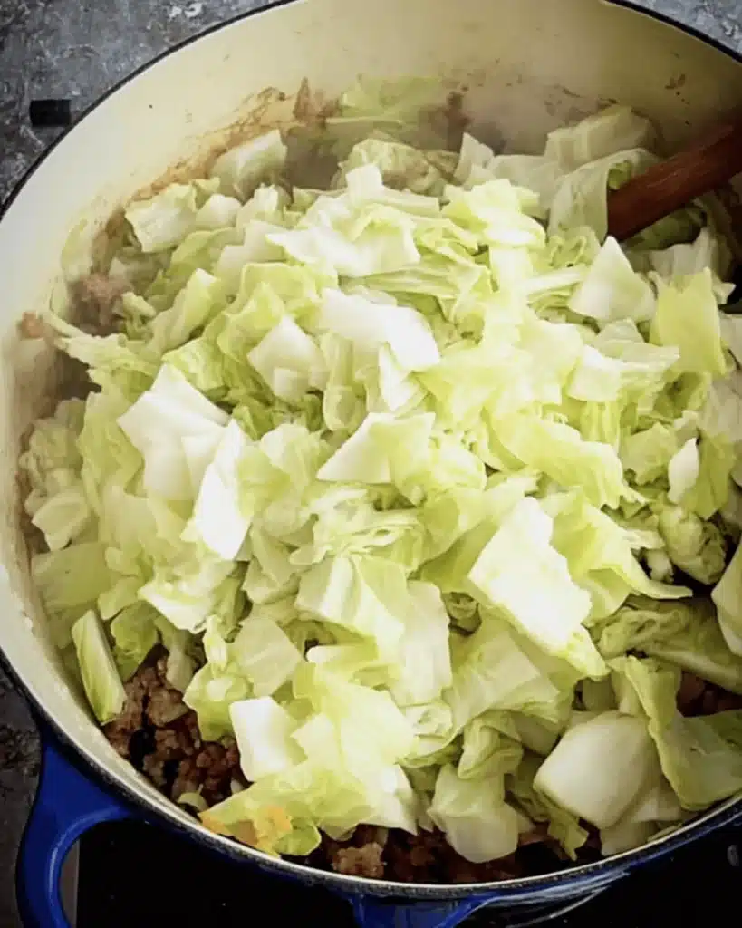 Golumpki Soup (Stuffed Cabbage Soup) – A Hearty Polish Classic Made Easy 3 Fresh cabbage added to sausage and onions for Golumpki Soup