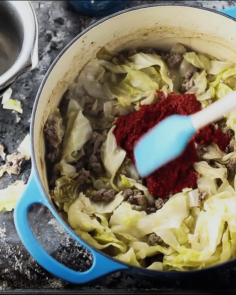 Golumpki Soup (Stuffed Cabbage Soup) – A Hearty Polish Classic Made Easy 4 Tomato paste added to cabbage and sausage for Golumpki Soup