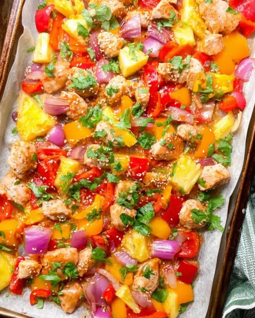 Hawaiian Chicken Sheet Pan Recipe (Easy, Healthy, and Flavorful) 1 Colorful Hawaiian chicken sheet pan with pineapple, bell peppers, and onions
