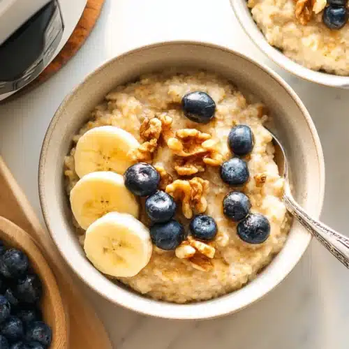 Instant Pot Steel Cut Oats 6 Creamy Instant Pot steel cut oats with bananas, blueberries, and walnuts in a bowl