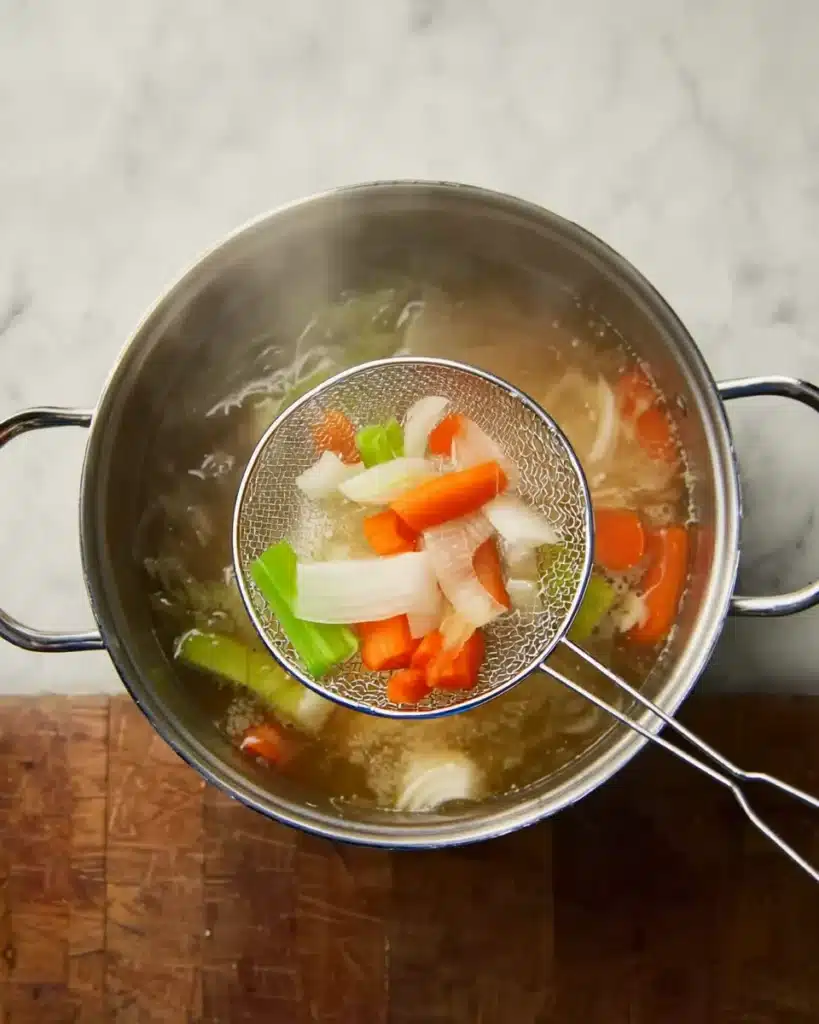 Italian Penicillin Soup Recipe Overview 2 Simmering broth with carrots, onions, and celery for Italian Penicillin Soup