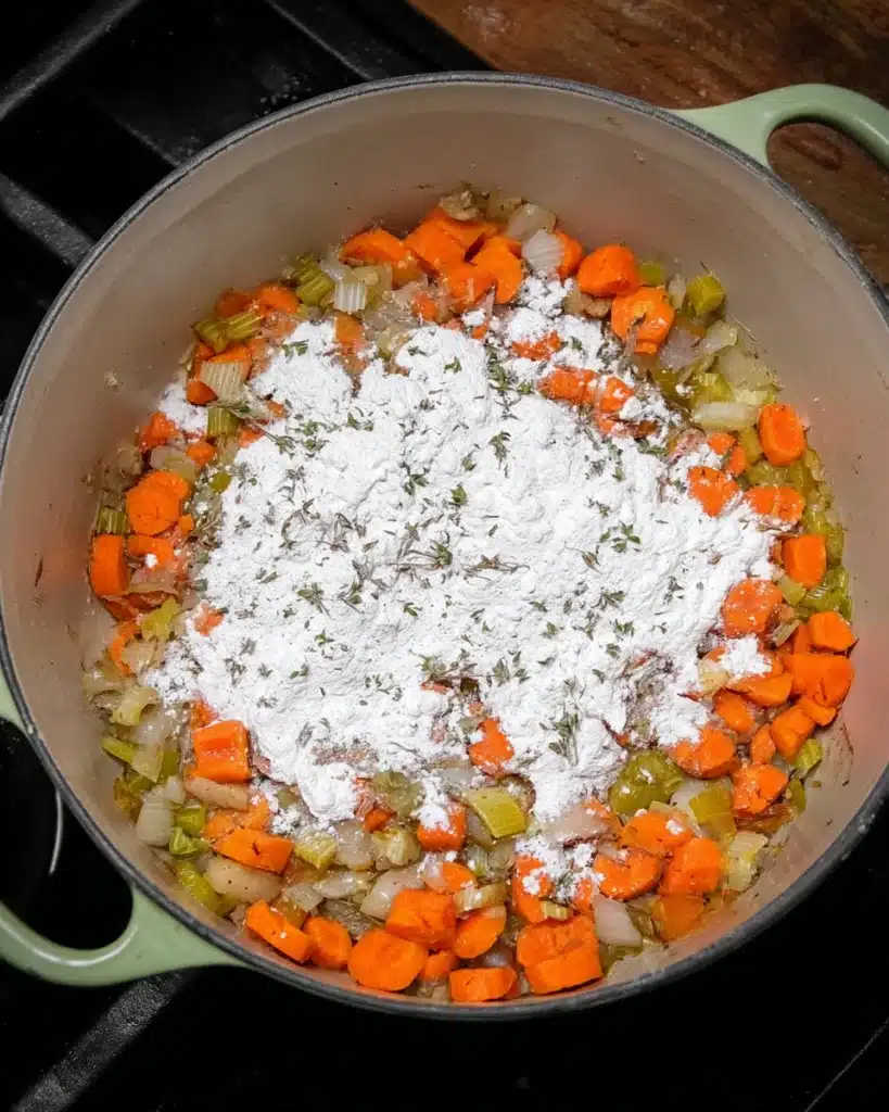 Italian Sausage and White Bean Soup (with Tuscan Kale) 5 Adding flour to sautéed carrots, onions, and celery for Italian sausage and white bean soup