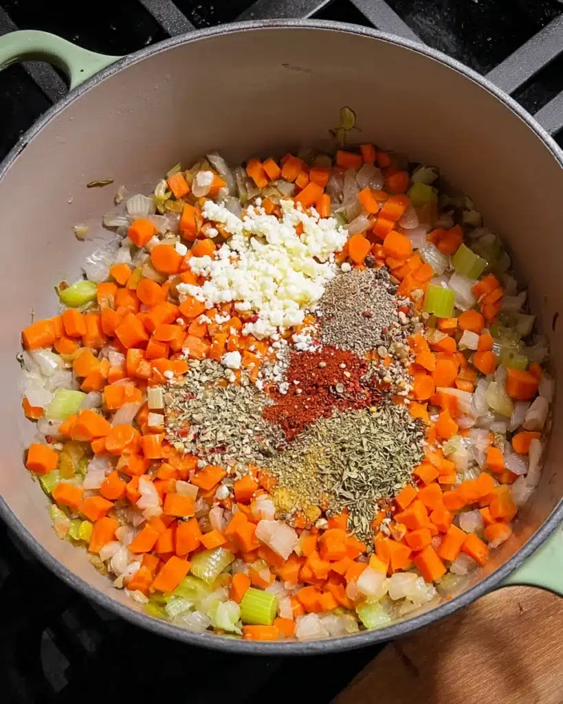 Italian Sausage and White Bean Soup (with Tuscan Kale) 4 Sautéed carrots, onions, and celery with garlic and Italian seasoning in a pot