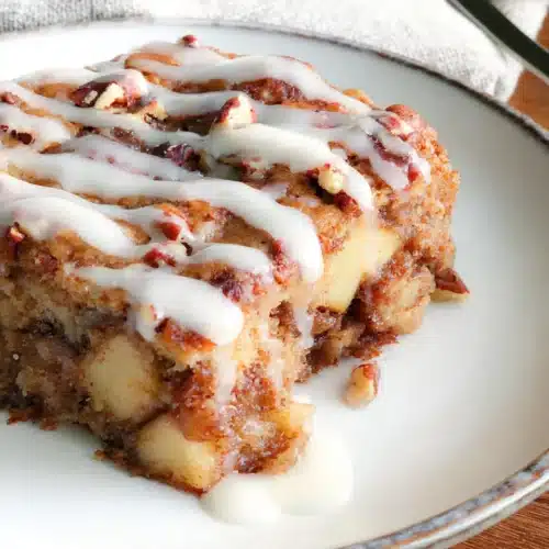 Slice of Oatmeal Apple Breakfast Bake with icing and chopped nuts