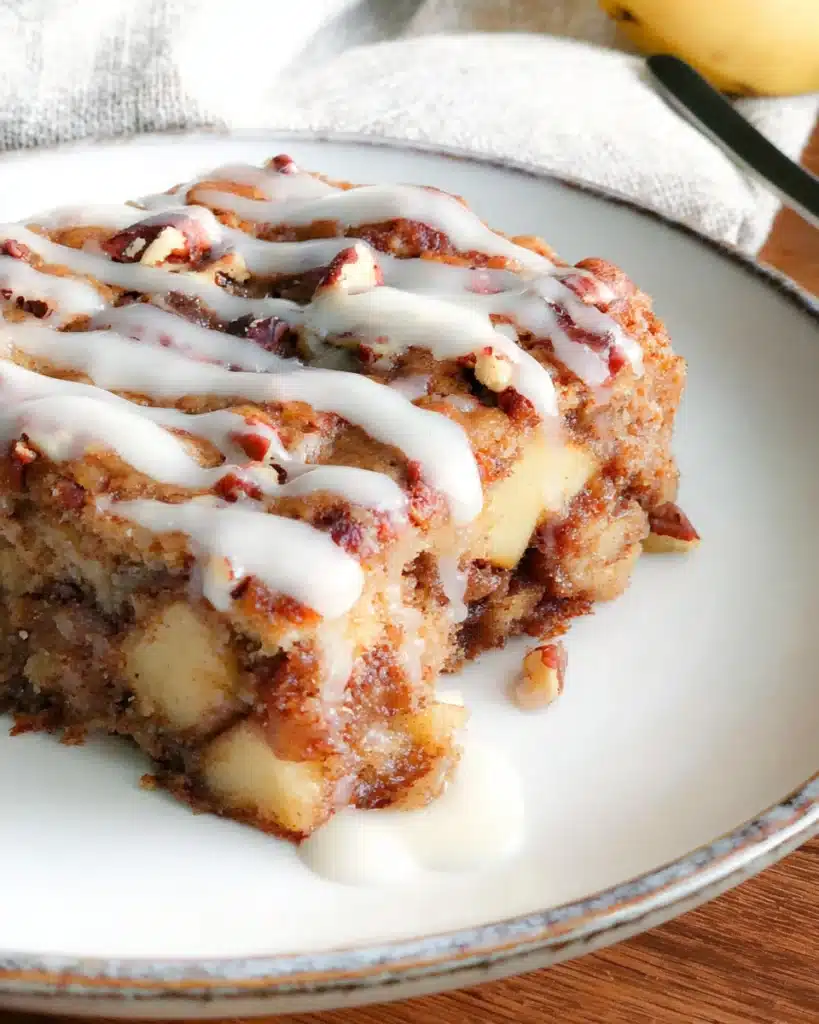 Slice of Oatmeal Apple Breakfast Bake with icing and chopped nuts