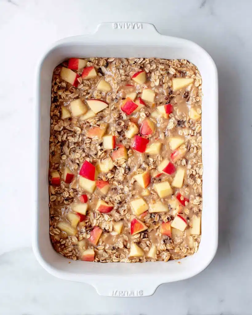 Oatmeal Apple Breakfast Bake mixture in white baking dish before baking