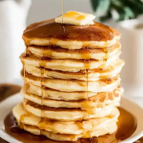Pancakes – Fluffy, Quick, No-Fail 7 Fluffy pancakes stacked with butter and syrup dripping down for a cozy breakfast