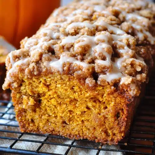 Pumpkin Streusel Bread 5 Freshly baked pumpkin streusel bread loaf with crumb topping and maple glaze
