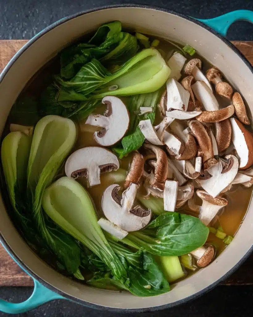 Quick & Easy Wonton Soup Recipe 3 Adding shiitake mushrooms and bok choy to wonton soup broth